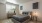 Apartments In Vacaville, CA For Rent - Strada 1200 - Bedroom With Vinyl Plank Flooring, Area Rug, Bed, Nightstands with Lamps, Dresser, and Window with Blinds